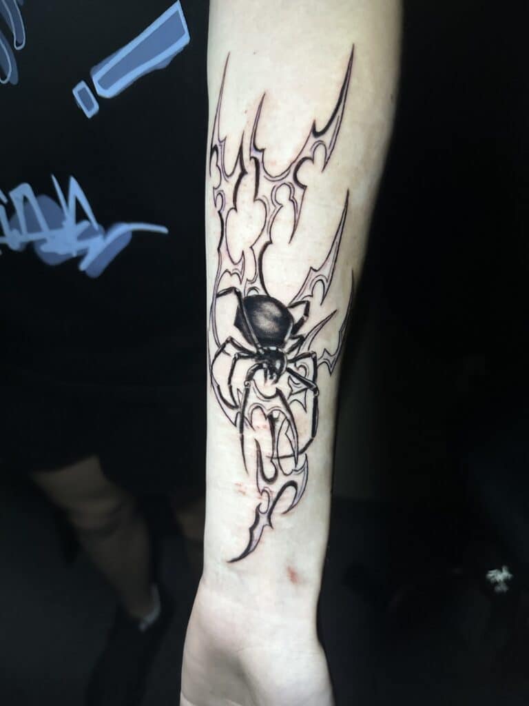 Spider tattoo over forearm