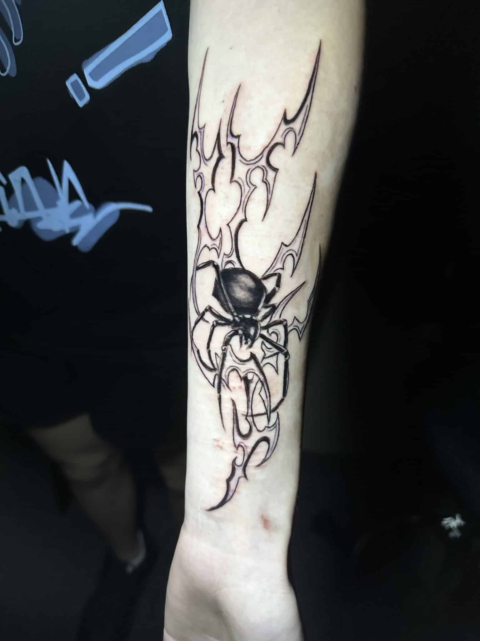 Spider tattoo over forearm