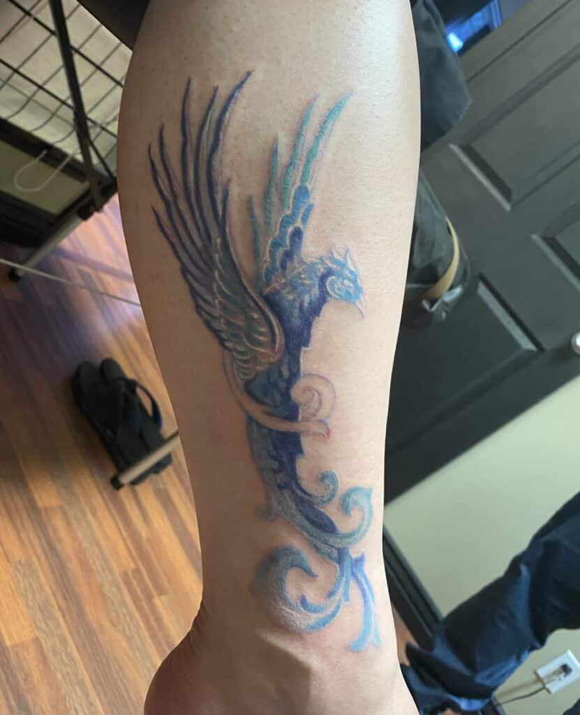 The pain involved with this ice phoenix  leg tattoo by Vitalii isn't that bad.